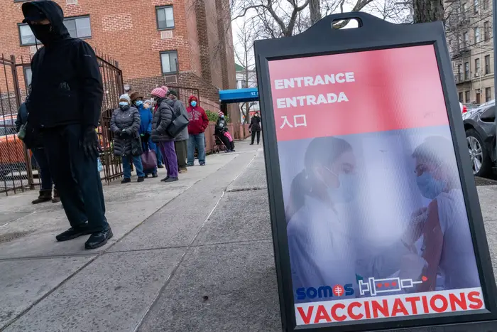 People wait in line for their first dose of the COVID-19 vaccination at a pop-up vaccination site at St. Luke's Episcopal Church in the Bronx on January 26th, 2021.
